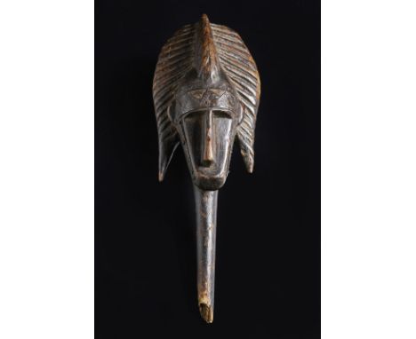 African art Malui, Marka/Bamana.Merekum puppet head.Wood and metal. . Cm 11,00 x 30,00. This wooden head features a structure