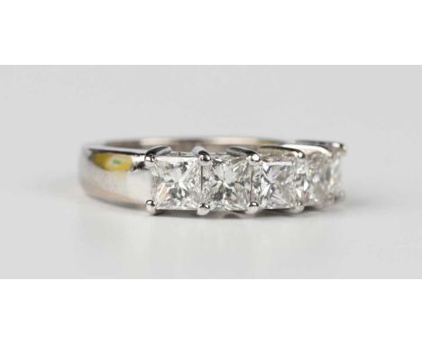 A diamond five stone ring, claw set with a row of princess cut diamonds, unmarked, weight 8.3g, total diamond weight approx 2