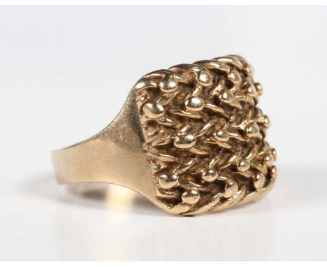 A 9ct gold ring in a beaded and interwoven keeper design, weight 12.3g, ring size approx Z+31/2.