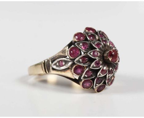 A gold, silver set and ruby harem ring, designed as a flowerhead, detailed ‘14K’, weight 8.5g, ring size approx P1/2.