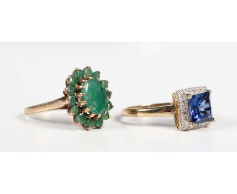 A 9ct gold and emerald oval cluster ring, the principal oval cut emerald within a surround of circular cut emeralds, London 1