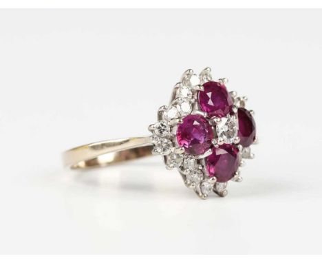 A gold, ruby and diamond cluster ring, claw set with principal circular cut diamond within a surround of four circular cut ru