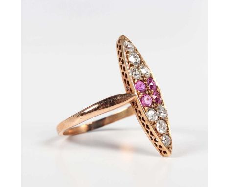 A gold, ruby and diamond marquise shaped cluster ring, mounted with four cushion cut rubies to the centre, otherwise mounted 