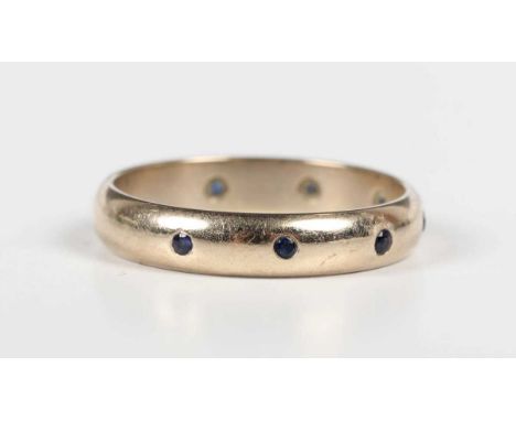 An 18ct gold and sapphire ring, gypsy set with a row of five circular cut sapphires, Sheffield 1995, weight 3.7g, ring size a