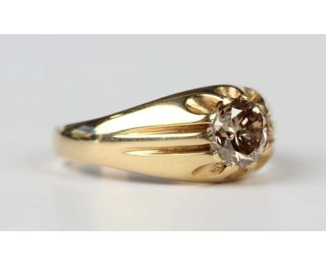 An 18ct gold and diamond single stone ring, mounted with a circular cut champagne coloured diamond, London 2004, weight 6g, d