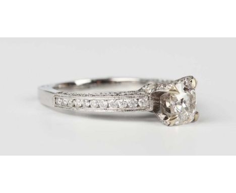 A 14ct white gold and diamond ring, claw set with the principal old cut diamond in a raised setting, otherwise mounted with c