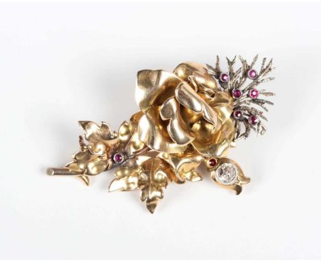 A gold, diamond and ruby brooch, designed as a floral spray, unmarked, weight 12.8g, width 4.9cm.