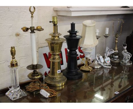 An Empire style brass two branch table lamp, a further brass table lamp, wrought iron lamp stand and related lamps and shades
