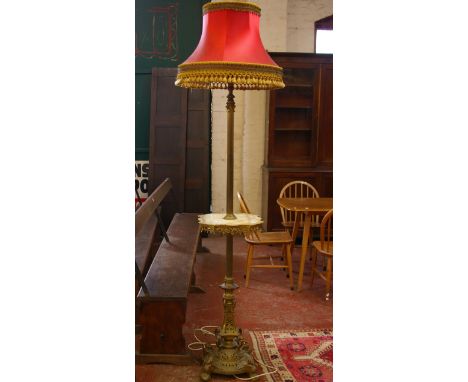 A late Victorian brass and marble standard lamp within Corninthian style column support on spreading pierced base terminating