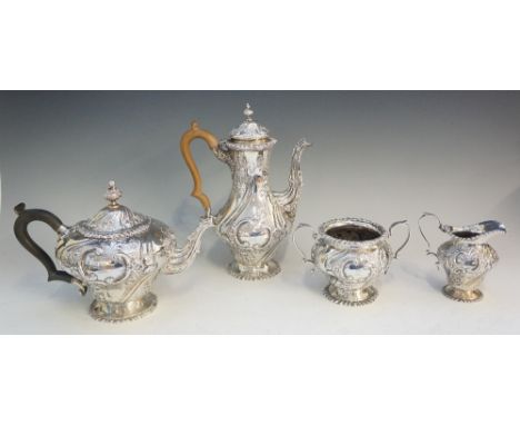 A four piece silver tea service comprising: teapot, coffee pot, sucrier and cream jug, all chased and embossed with lobed scr