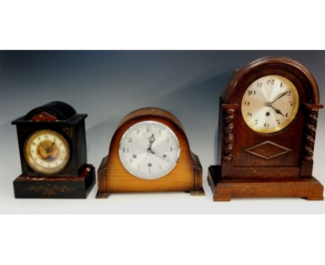 A collection of three mantel clocks comprising: a black slate and red marble example, arabic numerals, 25cm high, 19.5cm wide