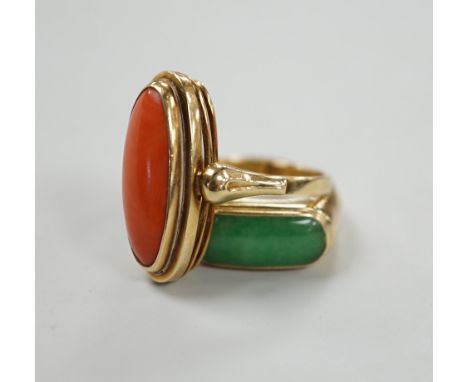 A 14ct and coral set oval ring, size O/P and a 14k and cabochon jade set ring, size P, gross weight 10.3 grams.