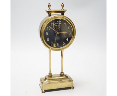 A 1920s brass gravity clock by the Watson Clock Co., stamped PAT15238/19, with vertical balance escapement, 26cm high