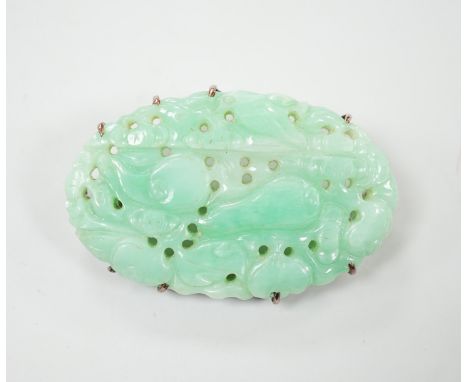 A Chinese yellow metal mounted carved jade oval brooch, 43mm, gross weight 15.8 grams