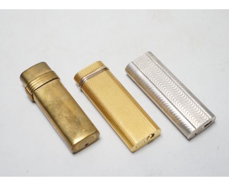 Two Cartier cigarette lighters and Christian Dior example