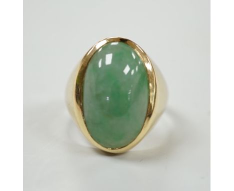 A modern 18ct gold and cabochon oval jade set ring, size P, gross weight 8.8 grams.