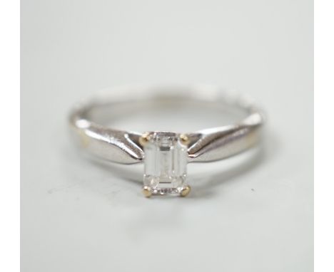 A 750 white metal and solitaire emerald cut diamond ring, size J/k, gross weight 2.9 grams.