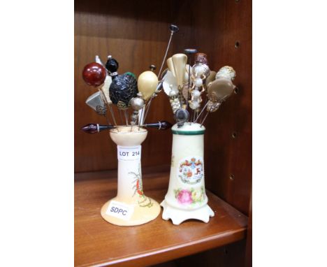TWO CERAMIC HAT PIN HOLDERS containing a variety of hat pins 