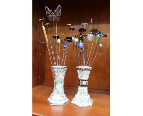TWO CERAMIC HAT PIN HOLDERS containing a variety of hat pins 