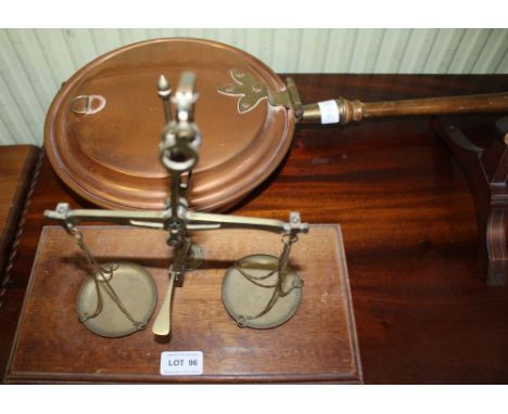 A COPPER HEADED WOODEN SHAFTED WARMING PAN together with a set of brass balance scales on rectangular mahogany plinth 
