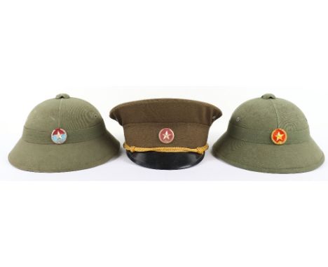 3x North Vietnamese Army (N.V.A) Headdress Pieces, consisting of two pith helmets both with badges to the centre. Paper maker