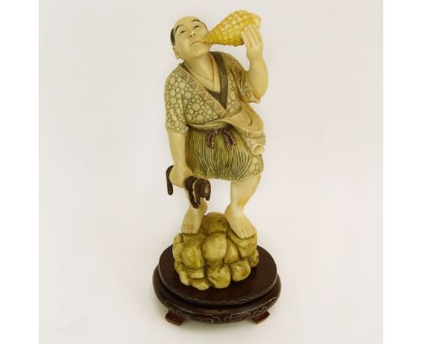 Mid 20th Century Japanese Carved Ivory with wood base, Man with Sea Shell. Signed to base. Good condition. Measures 6-1/2" H,