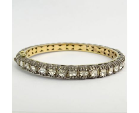 14 Karat Yellow Gold, Silver and Diamond Bangle Bracelet. Unsigned. Good condition. Measures 1/4" W, 2-3/8" interior diam. Ap