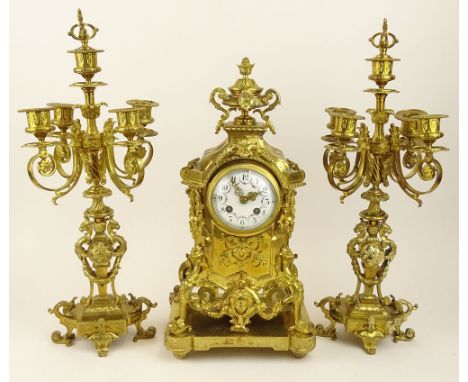 Antique Three (3) piece French ormolu bronze clock garniture set. Figural motif, hand painted dial. The clock flanked by 2 fi