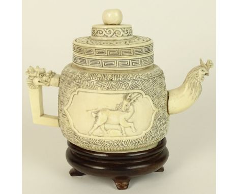 Antique Chinese Carved Ivory Teapot. Signed. Loose spout otherwise good condition. Measures 5" H, 6-1/4" W. This item will on