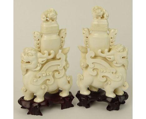 Pair of Vintage well carved Ivory Foo Lion Urns on Hardwood Stands. Unsigned. Age cracks or in good condition. Measures 6-1/4