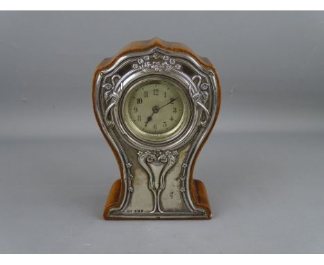 A SILVER FRONTED OAK MANTEL CLOCK in the Art Nouveau style, Birmingham 1909, 15.5 cms high