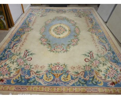 A CHINESE WASHED WOOLLEN CARPET, predominantly cream ground with multiple floral pattern, 376 x 275 cms 