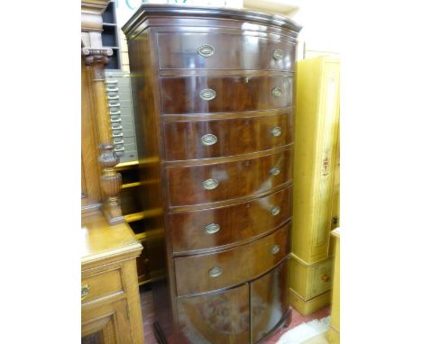 A TALL MAHOGANY BOW FRONT CHEST OF SIX DRAWERS with two door lower shoe cupboard on corner bracket feet, 195.5 cms high, 94 c