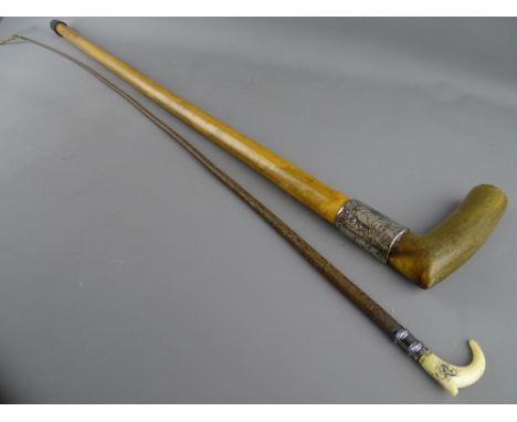 AN IVORY TOPPED RIDING CROP and a horn handled walking stick with wide silver collar, 94 and 89 cms long, the ivory monogramm