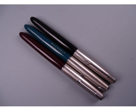 Three Vintage Parker 51 fountain pens (black, red, and green with engraved barrel)
