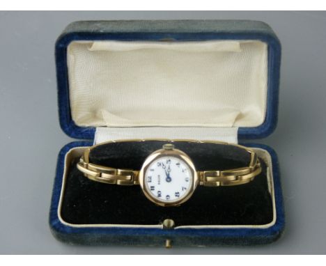 A NINE CARAT GOLD LADY'S WRISTWATCH with bracelet strap, the white enamel dial marked 'Rolco', 17.5 grms gross