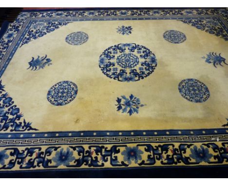 A LARGE BLUE & CREAM WASHED WOOLLEN CHINESE CARPET with tasselled ends, 375 x 276 cms