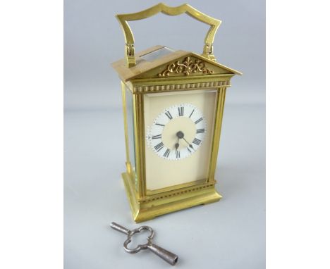 AN ARCHITECTURAL BRASS CASED CARRIAGE CLOCK, late 19th Century with later changes, 15.5 cms high handle up, with key