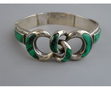 A SILVER & MALACHITE BANGLE having five oblong malachite panels with a quadruple silver and malachite loop, 25 grms total