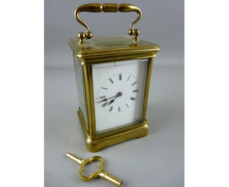 A BRASS CASED CARRIAGE CLOCK with gong strike movement, 16 cms high handle up, with key