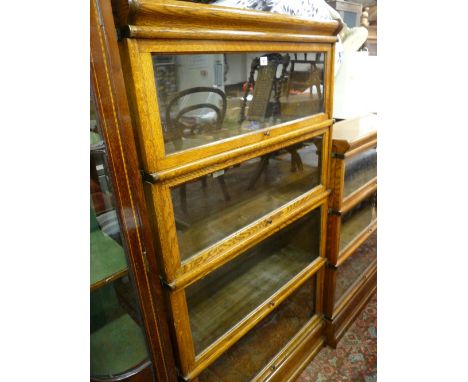 A GLOBE WERNICKE LIGHT OAK FOUR SECTION STACKING BOOKCASE with labels, 161 cms high, 87 cms wide, 31 cms deep