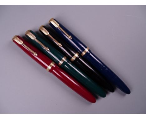 Four Vintage Parker Duofold fountain pens (black, blue, green, red) including one Maxima, all with 14k nibs