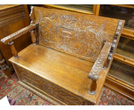 A GOOD CARVED OAK BOX SEAT MONK'S BENCH, 79 cms high closed, 105 cms wide, 47.5 cms deep