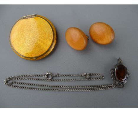 A CIRCULAR ORANGE ENAMEL & YELLOW METAL COMPACT, a silver chain and amber stone pendant, 7.4 grms and a pair of composition c