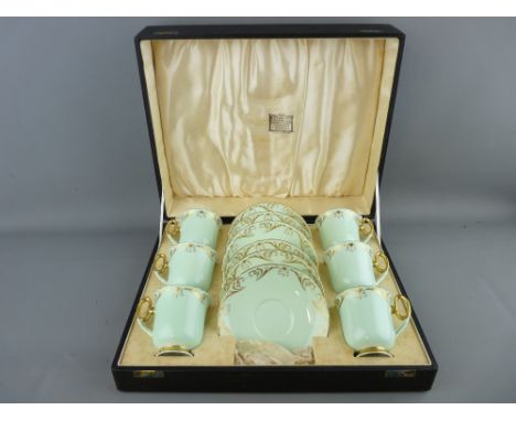 A CASED SET OF SIX SHELLEY BONE CHINA COFFEE CUPS & SAUCERS, mint colour with gilt highlighting, 'T W Long & Co, Goldsmiths &