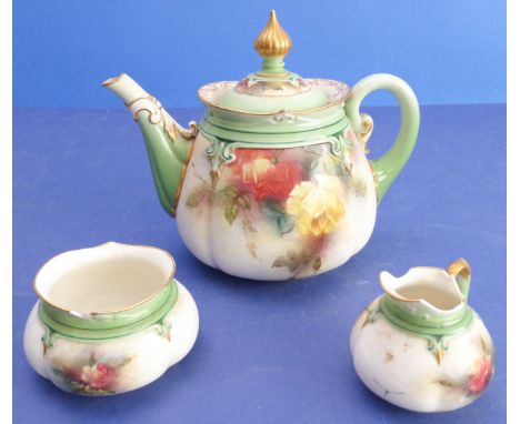 A late 19th / early 20th century three-piece porcelain tea service by Hadley's of Worcester: teapot, melon-shaped cream jug a