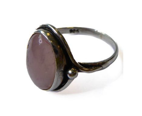 A silver dress ring; centrally set with a pink oval quartz style polished hardstone, ring size P (boxed)