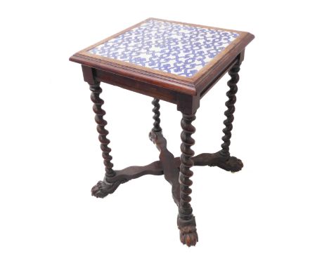 An unusual late 19th century square oak centre table; four blue-and-white ceramic tiles with a strapwork design above barleyt