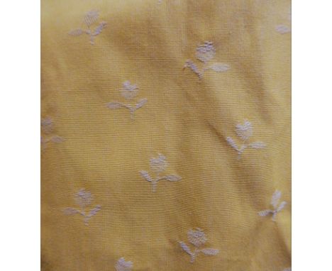A pair of yellow curtains with woven small floral pattern, edged with corded and fringed braid, triple pinch pleat heading, w