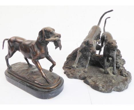 A heavy cast bronze of a gun dog with pheasant upon an oval variegated marble base (in the 19th century French animalier styl
